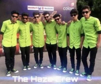 The Haze Crew posing together backstage in matching green shirts.