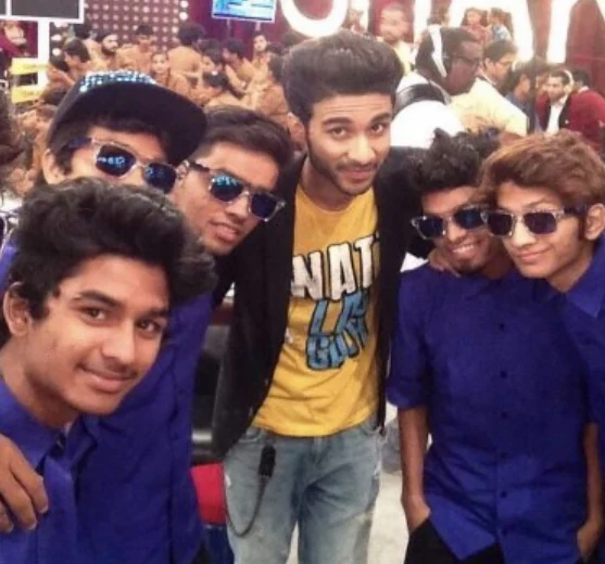 A group of dancers taking a selfie together at a busy event.
